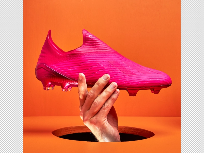 Professionally retouched product photo of Adidas soccer cleats with studs on artistic stand 1.jpg