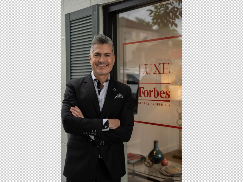Unedited portrait of a real estate agent in front of office with mixed lighting conditions and reflective background surfaces.jpg Unedited portrait of a real estate agent in front of office with mixed lighting conditions and reflective background surfaces.jpg