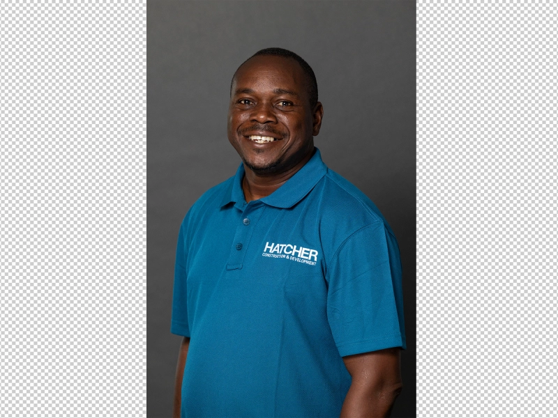 Before editing portrait of male employee with uneven lighting, visible skin imperfections, clothing wrinkles, and inconsistent background tone.jpg Before editing portrait of male employee with uneven lighting, visible skin imperfections, clothing wrinkles, and inconsistent background tone.jpg