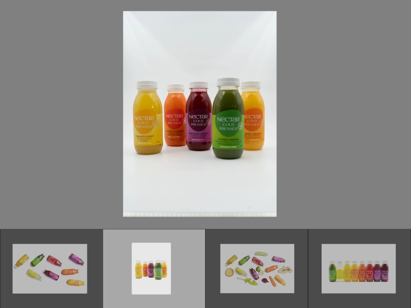 Before batch editing image of four beverage bottles standing together with uneven light, dull colors, soft details, and visible shadows.jpg Before batch editing image of four beverage bottles standing together with uneven light, dull colors, soft details, and visible shadows.jpg